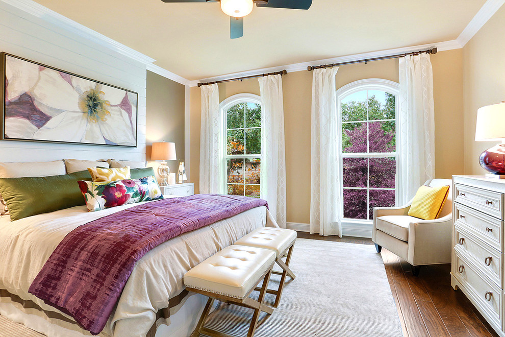 Transitional bedroom in New Orleans with beige walls and dark hardwood floors.