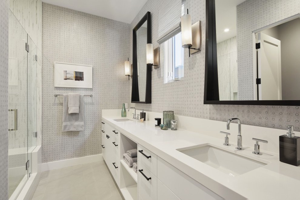 Design ideas for a mid-sized contemporary 3/4 bathroom in Orange County with flat-panel cabinets, white cabinets, white tile, grey walls, cement tiles, an undermount sink, engineered quartz benchtops, grey floor, a hinged shower door, white benchtops, a single vanity, a built-in vanity and wallpaper.