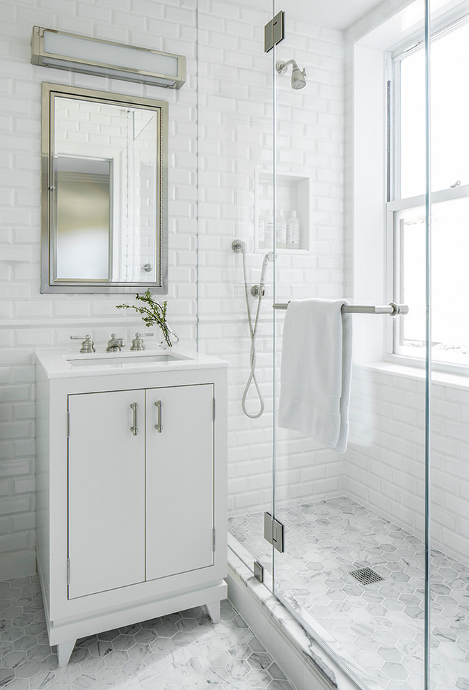 Photo of a small traditional 3/4 bathroom in New York with flat-panel cabinets, white cabinets, a double shower, white tile, subway tile, white walls, marble floors, a drop-in sink and marble benchtops.