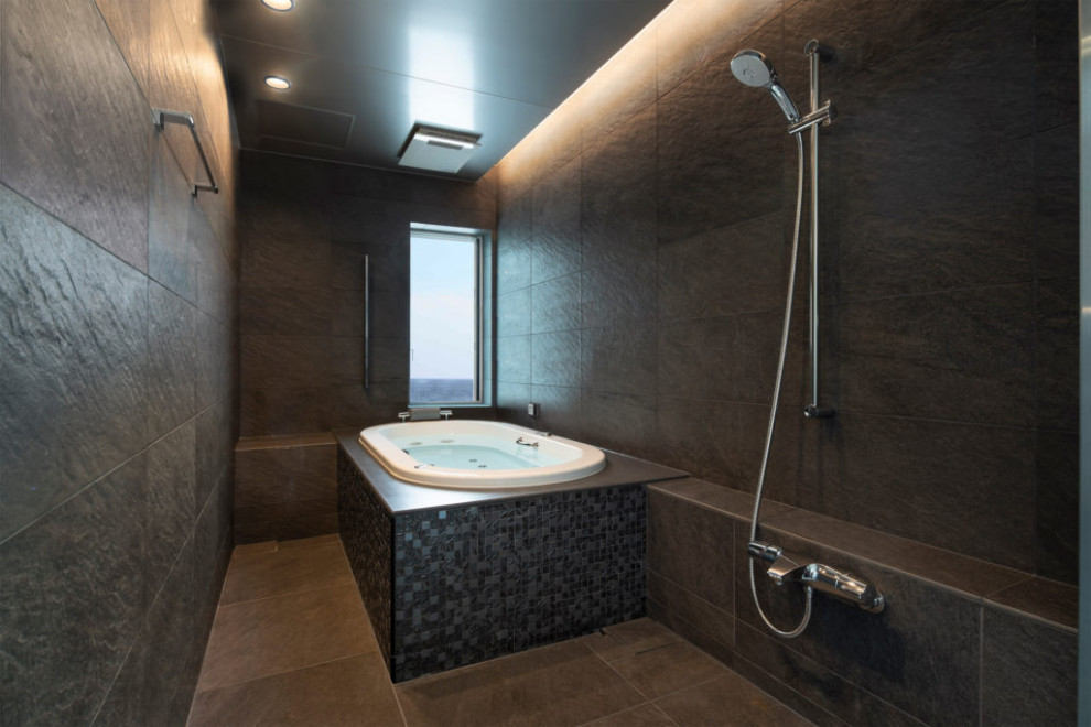 This is an example of a modern bathroom in Tokyo with black walls, porcelain floors, grey floor, a shower seat and recessed.