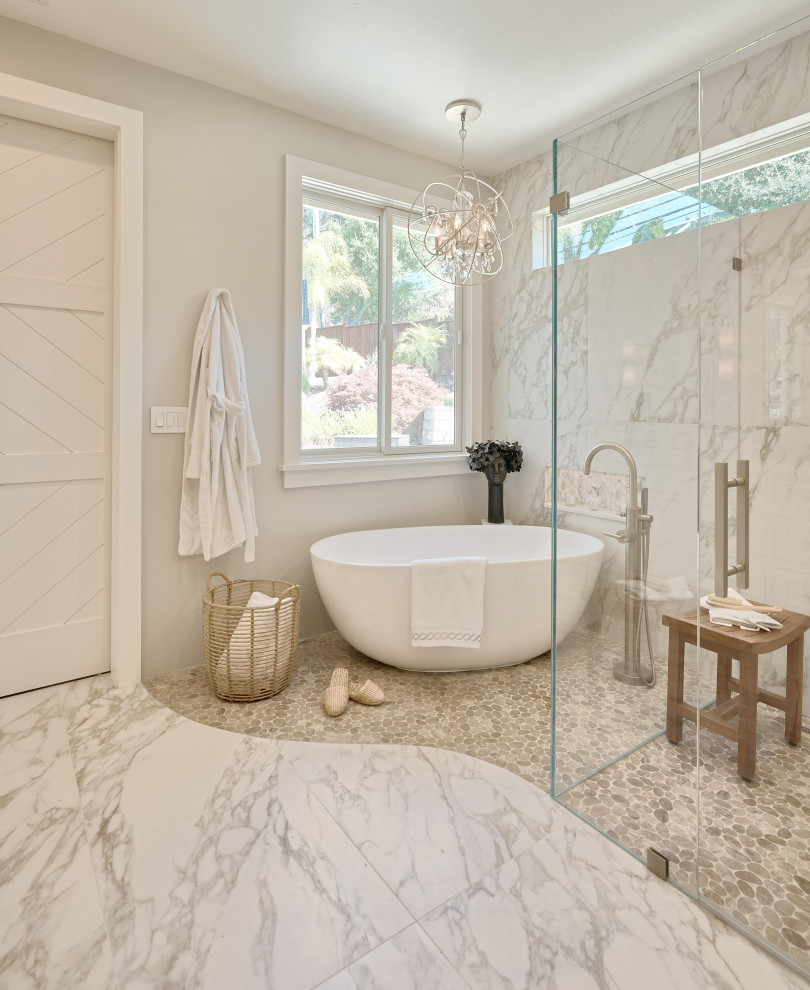 Photo of a large contemporary master bathroom in San Francisco with shaker cabinets, white cabinets, a freestanding tub, a curbless shower, a one-piece toilet, white tile, porcelain tile, grey walls, pebble tile floors, an undermount sink, engineered quartz benchtops, a hinged shower door, white benchtops, a double vanity and a built-in vanity.
