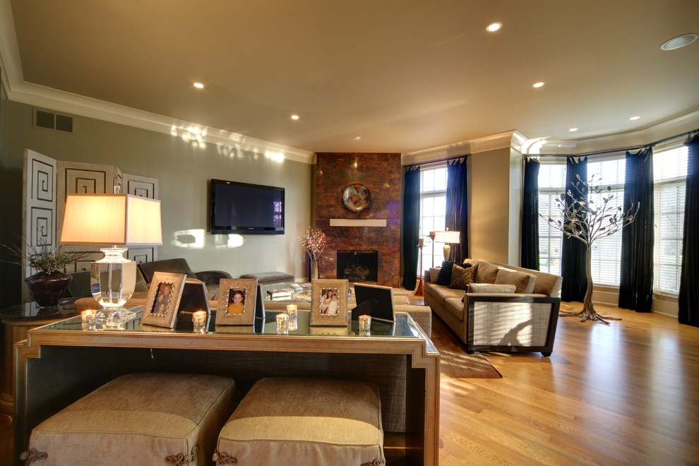 Inspiration for a transitional living room remodel with a corner fireplace, a metal fireplace and a wall-mounted tv