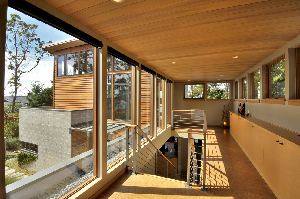 This is an example of a contemporary hallway in Seattle with medium hardwood floors and yellow floor.
