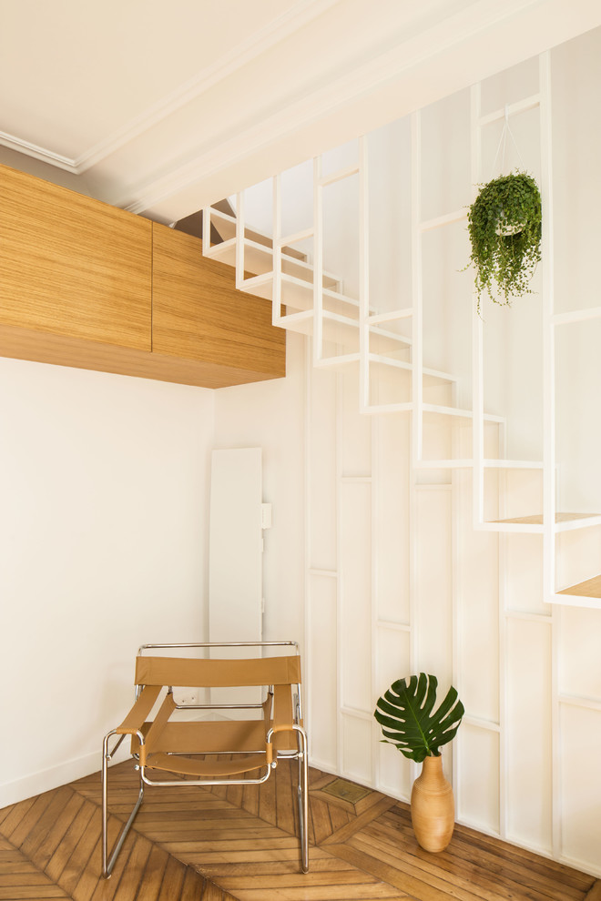 This is an example of a small contemporary wood staircase in Paris with open risers.
