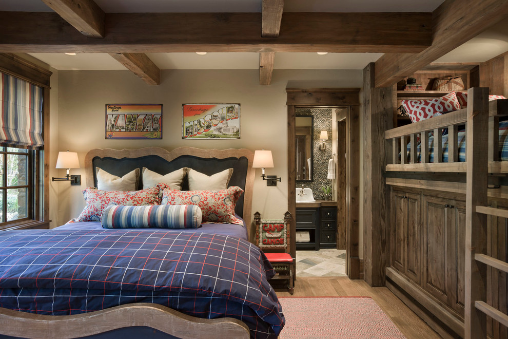 Design ideas for a country guest bedroom in Other with beige walls and medium hardwood floors.