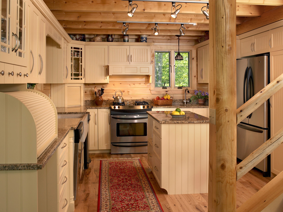Inspiration for a mid-sized country u-shaped open plan kitchen in Portland Maine with beige cabinets.
