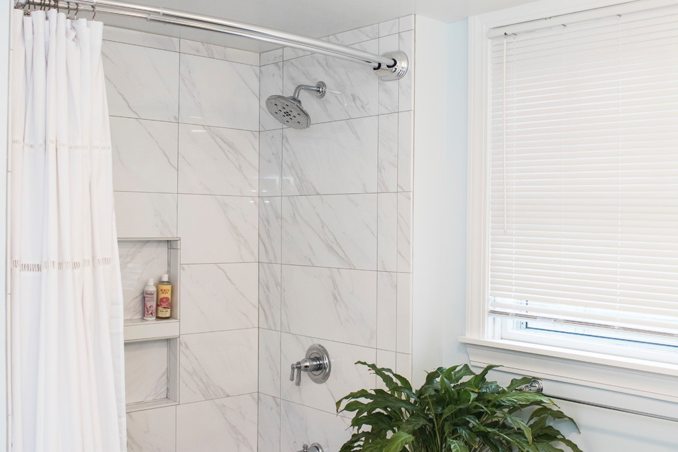 Photo of a mid-sized modern master bathroom in Providence with beaded inset cabinets, blue cabinets, a drop-in tub, an open shower, a one-piece toilet, white tile, ceramic tile, blue walls, ceramic floors, an undermount sink, tile benchtops, white floor and a shower curtain.