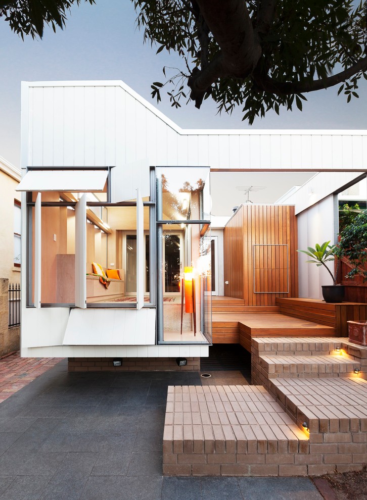 Inspiration for a contemporary white exterior in Perth with wood siding.