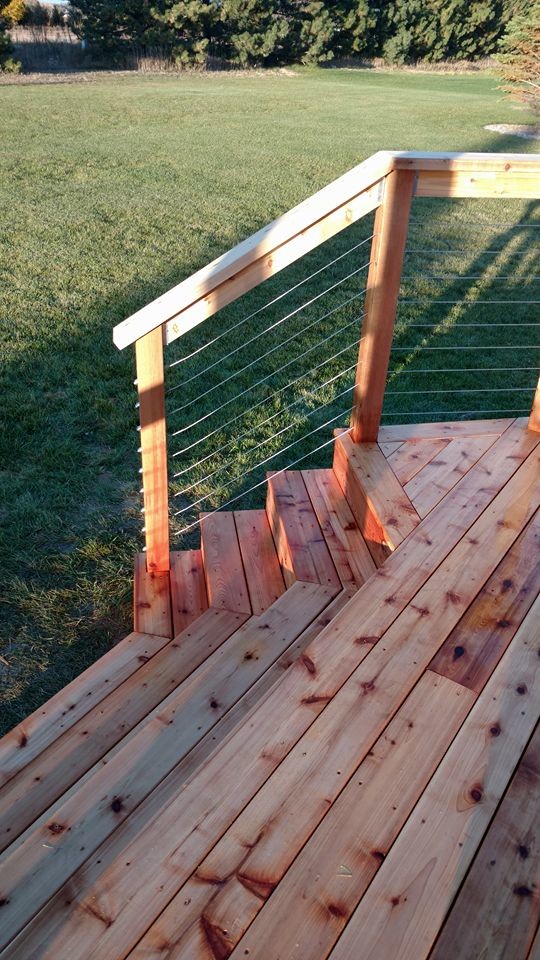 Large mountain style deck photo with a pergola