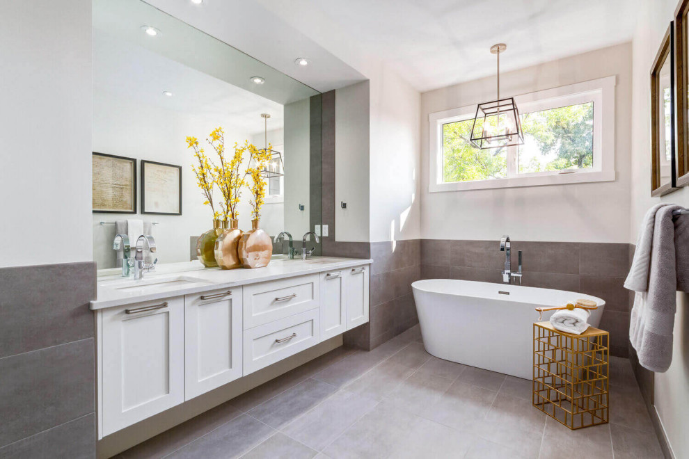 Photo of a medium sized classic bathroom in Calgary with shaker cabinets, white cabinets, a submerged bath, brown tiles, cement tiles, white walls, cement flooring, a submerged sink, engineered stone worktops, grey floors, white worktops, an enclosed toilet, double sinks and a floating vanity unit.