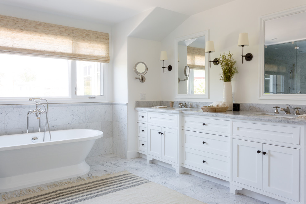 Photo of a beach style master bathroom in Los Angeles with beaded inset cabinets, white cabinets, a freestanding tub, gray tile, white walls, an undermount sink, grey floor and grey benchtops.