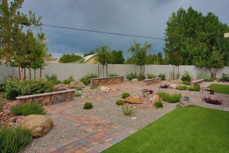 Design ideas for a mid-sized backyard formal garden in Las Vegas with brick pavers.