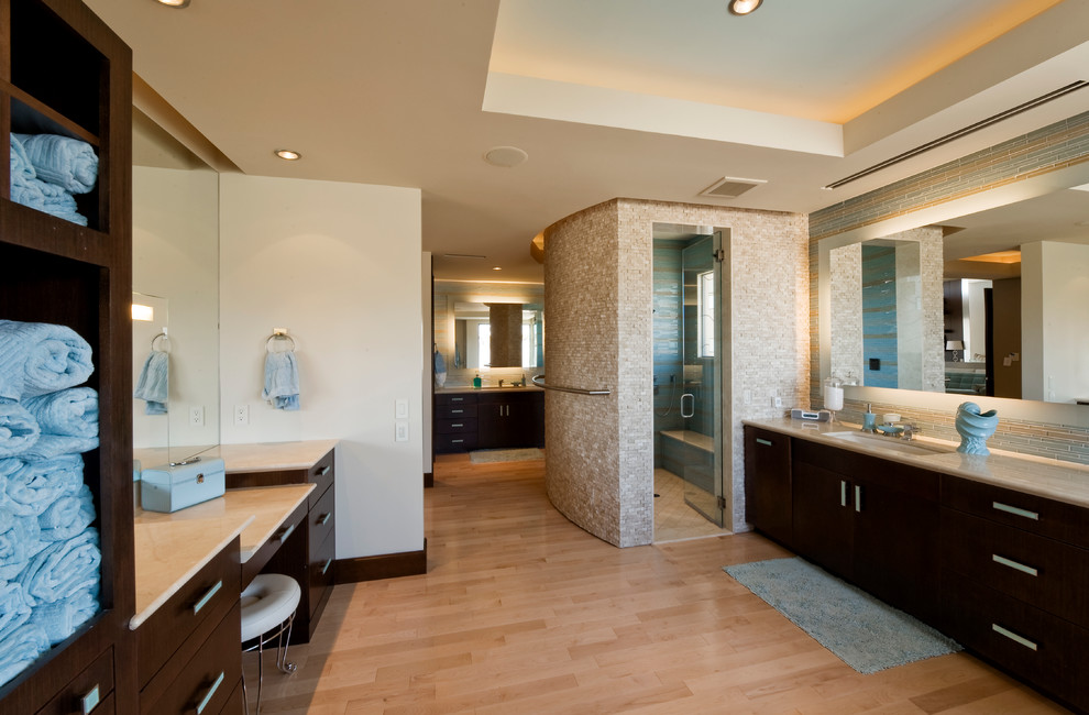 Design ideas for a contemporary bathroom in Las Vegas with flat-panel cabinets, dark wood cabinets, an alcove shower, beige tile and mosaic tile.