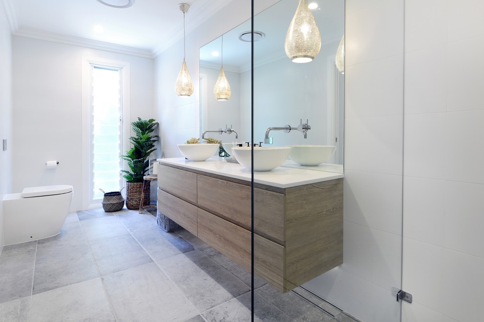 Inspiration for a mid-sized contemporary master bathroom in Sydney with white tile and solid surface benchtops.