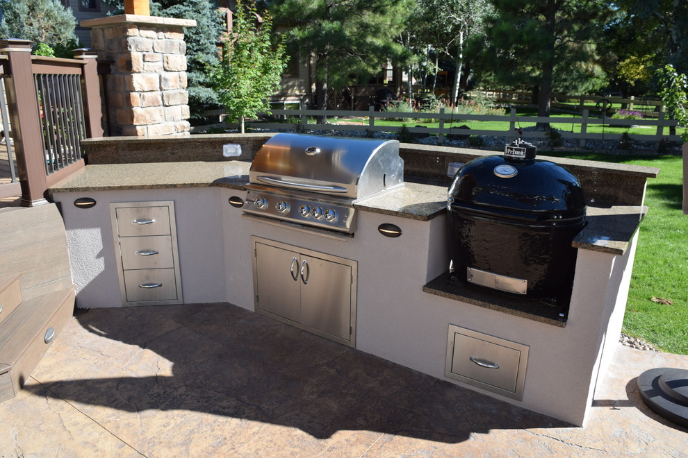 Mid-sized transitional backyard outdoor kitchen deck photo in Denver with a roof extension