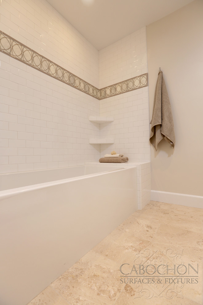 Inspiration for a mid-sized transitional 3/4 white tile and ceramic tile limestone floor drop-in bathtub remodel in San Diego with shaker cabinets, white cabinets, marble countertops, a two-piece toilet, an undermount sink and beige walls