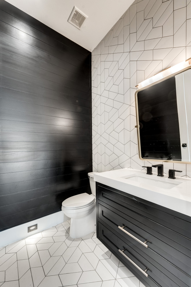 Design ideas for an arts and crafts powder room in Dallas with recessed-panel cabinets, black cabinets, a one-piece toilet, white tile, ceramic tile, black walls, ceramic floors, an undermount sink, engineered quartz benchtops, white floor, white benchtops, a floating vanity and planked wall panelling.