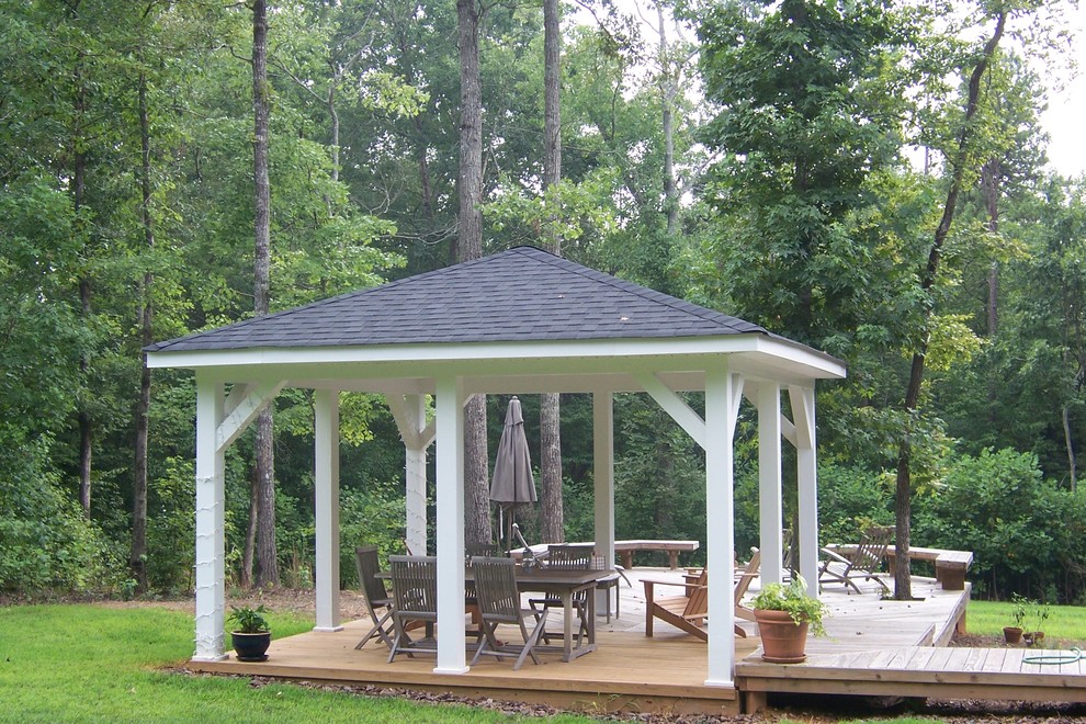 Photo of a mid-sized traditional backyard patio in Charlotte with decking and a pergola.
