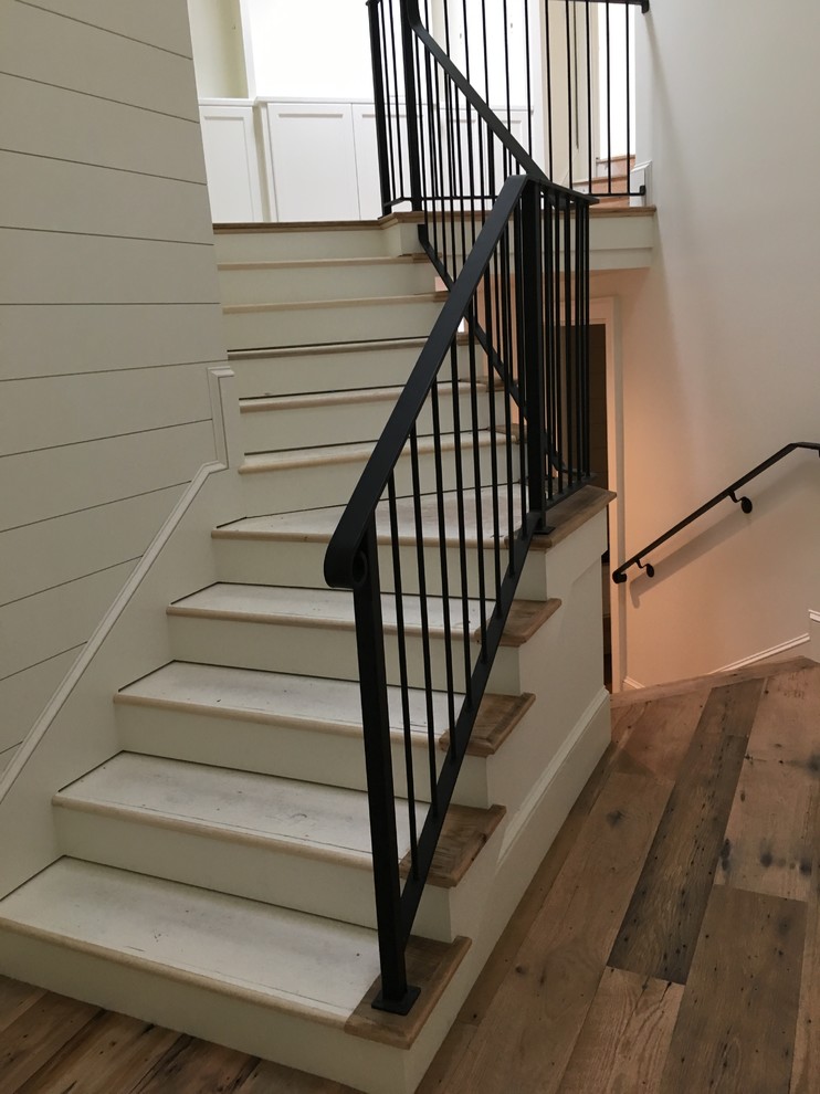 This is an example of a beach style curved staircase in Charleston.