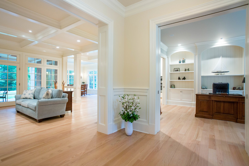 Design ideas for a mid-sized traditional foyer in Other with white walls and light hardwood floors.