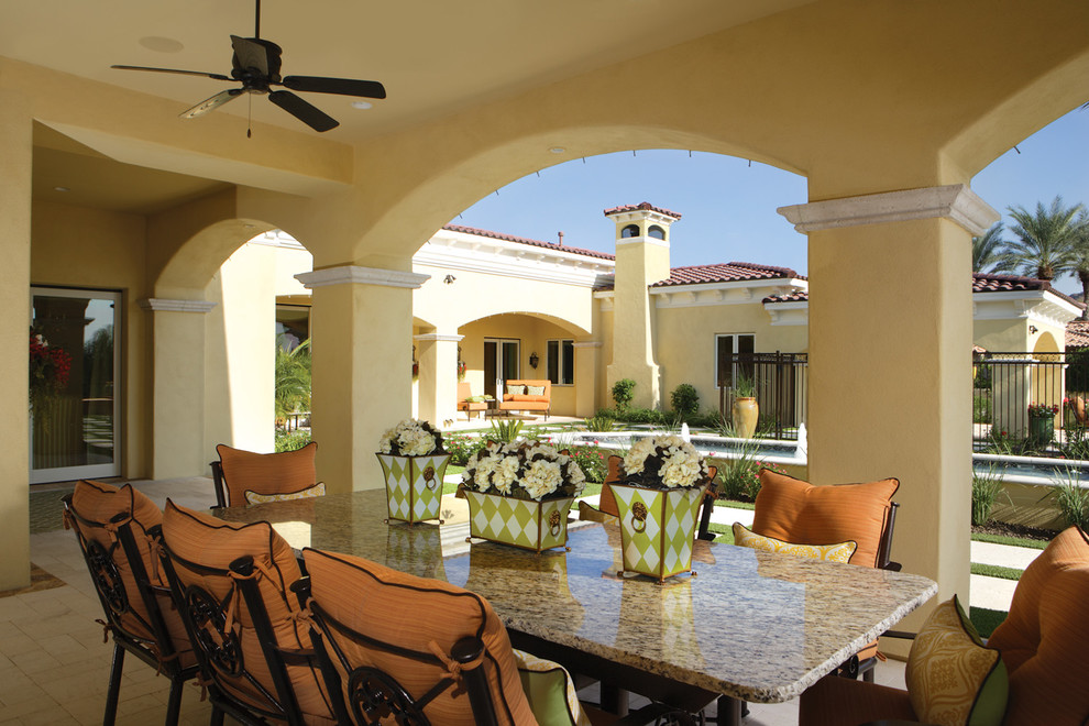 Expansive mediterranean backyard patio in Phoenix with an outdoor kitchen, natural stone pavers and a gazebo/cabana.