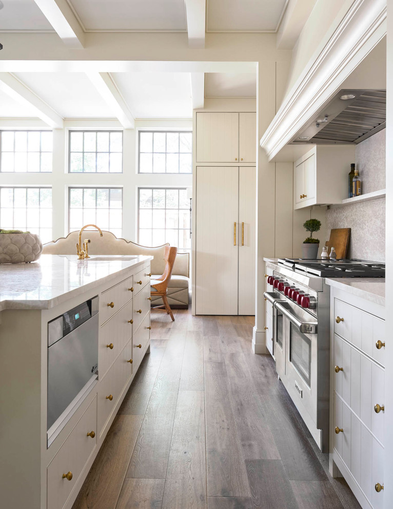 Eat-in kitchen - large transitional u-shaped medium tone wood floor eat-in kitchen idea in Dallas with an undermount sink, flat-panel cabinets, white cabinets, quartz countertops, multicolored backsplash, mosaic tile backsplash, paneled appliances and an island