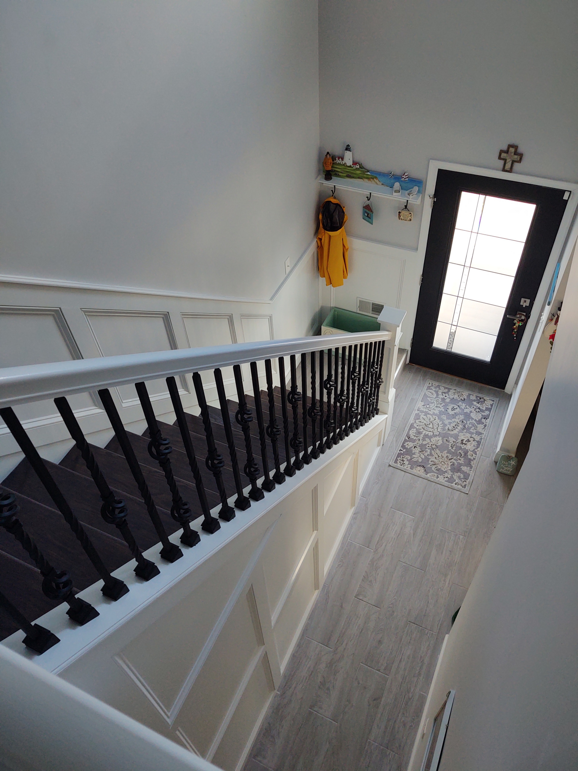 Wainscoting along lower and upper stair walls