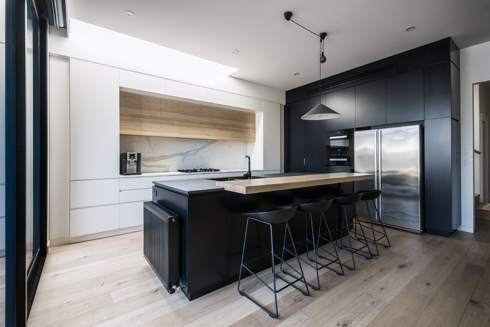Mid-sized modern l-shaped eat-in kitchen in Melbourne with flat-panel cabinets, medium wood cabinets, marble benchtops and with island.