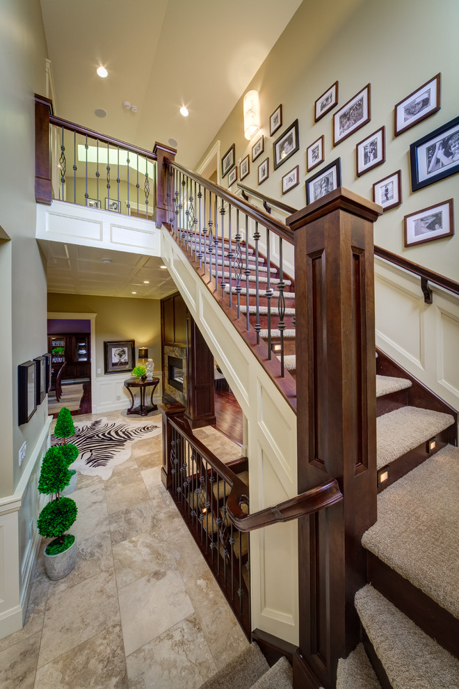 Photo of a mid-sized transitional carpeted l-shaped staircase in Calgary with wood risers.