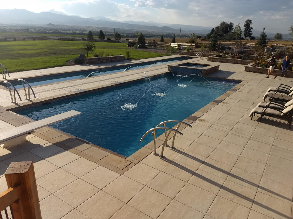 Inspiration for a mid-sized backyard rectangular lap hot tub remodel in Denver