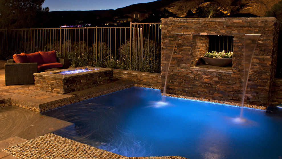 Design ideas for a medium sized contemporary back custom shaped swimming pool in Las Vegas with with pool landscaping and concrete paving.