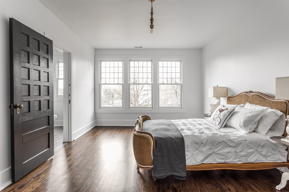 Photo of a bedroom in Indianapolis with white walls, dark hardwood floors and brown floor.