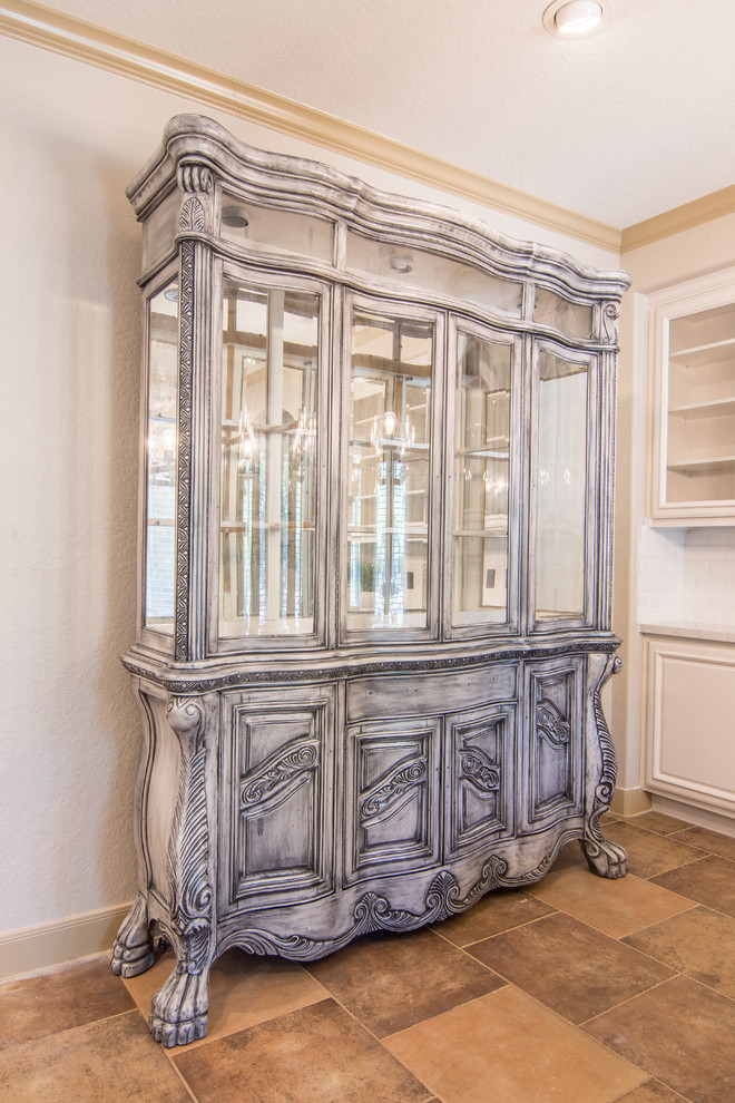 Example of a large classic u-shaped ceramic tile eat-in kitchen design in Houston with a farmhouse sink, raised-panel cabinets, white cabinets, quartzite countertops, white backsplash, subway tile backsplash, stainless steel appliances and an island
