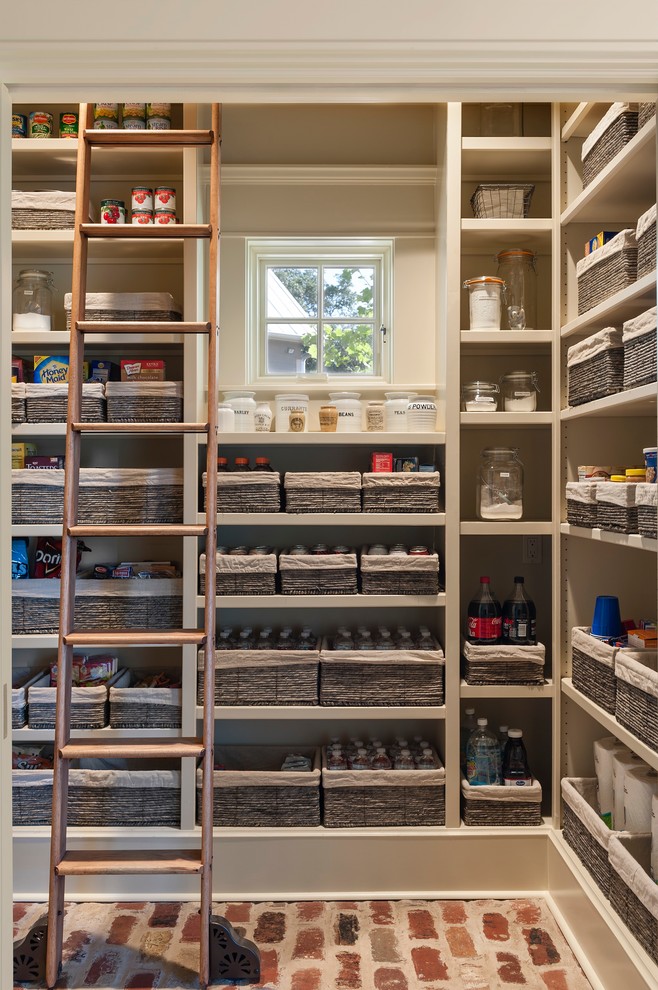 Inspiration for a country kitchen pantry in Houston with open cabinets, beige cabinets and brick floors.