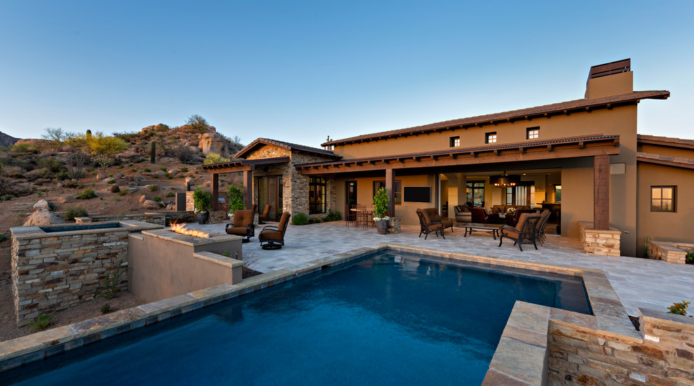 Inspiration for a transitional backyard rectangular pool in Phoenix with natural stone pavers.