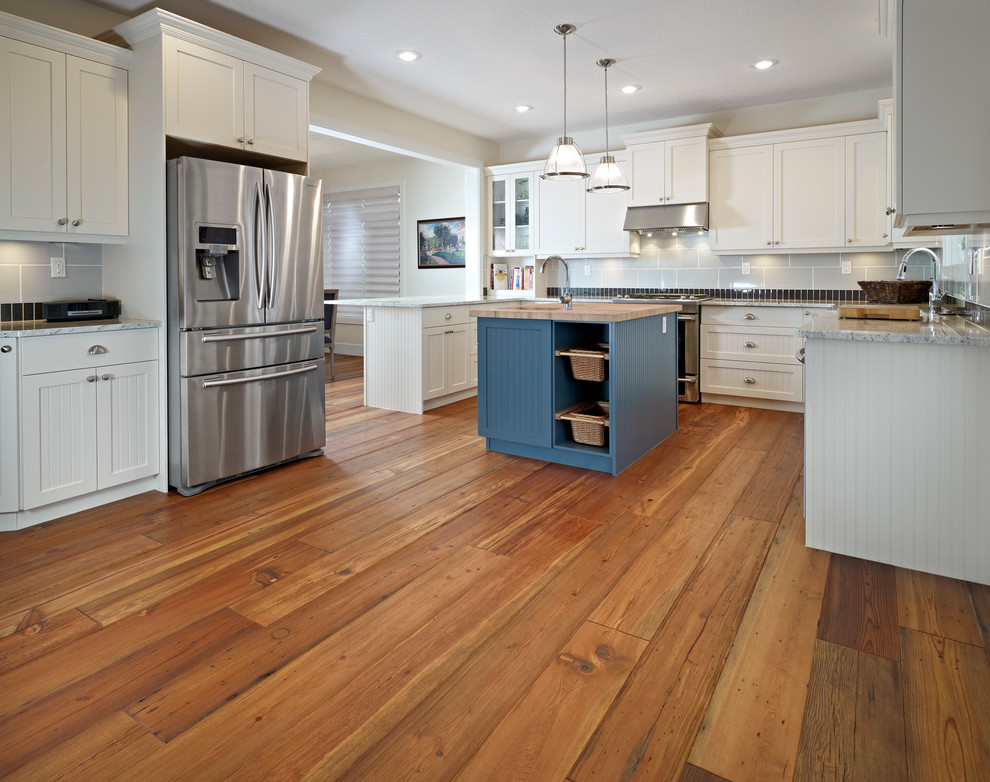 Design ideas for a traditional kitchen in Edmonton with shaker cabinets, white cabinets, wood benchtops, grey splashback, subway tile splashback and stainless steel appliances.