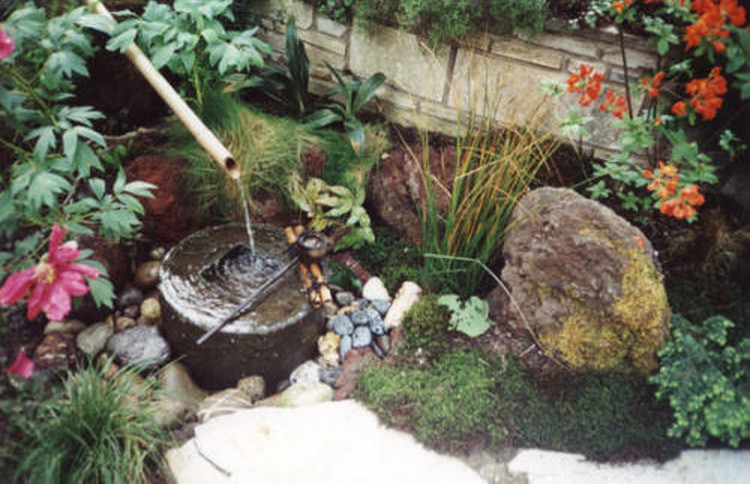 Design ideas for a small asian garden for summer in Frankfurt with a water feature.