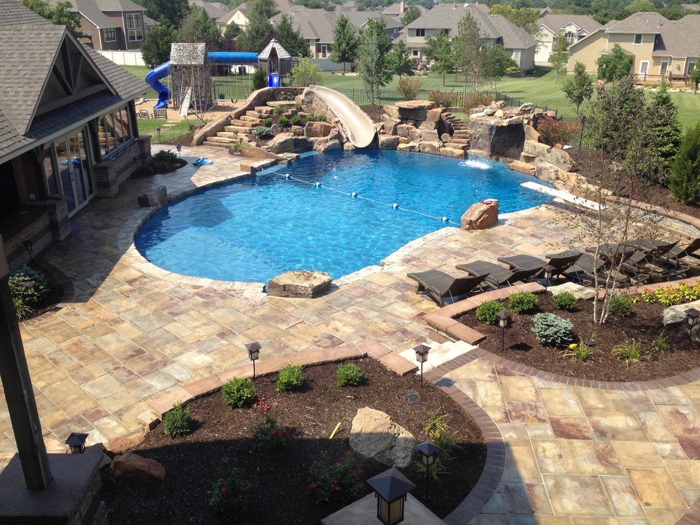 Photo of a traditional pool in Kansas City with a water slide.