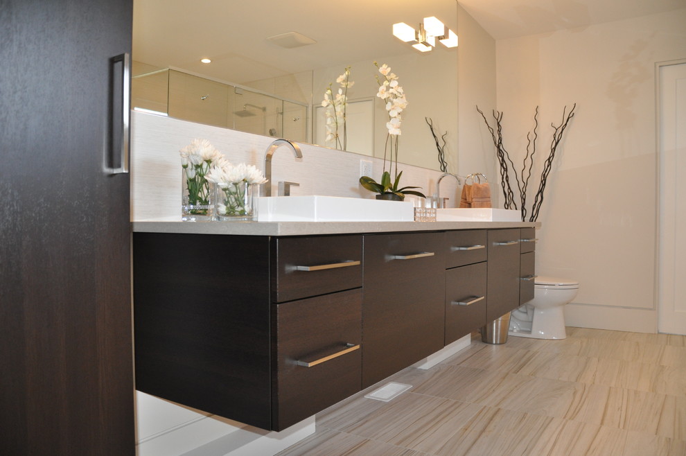 This is an example of a large modern master bathroom in Toronto with an undermount sink, raised-panel cabinets, dark wood cabinets, granite benchtops, a drop-in tub, an open shower, a one-piece toilet and ceramic tile.