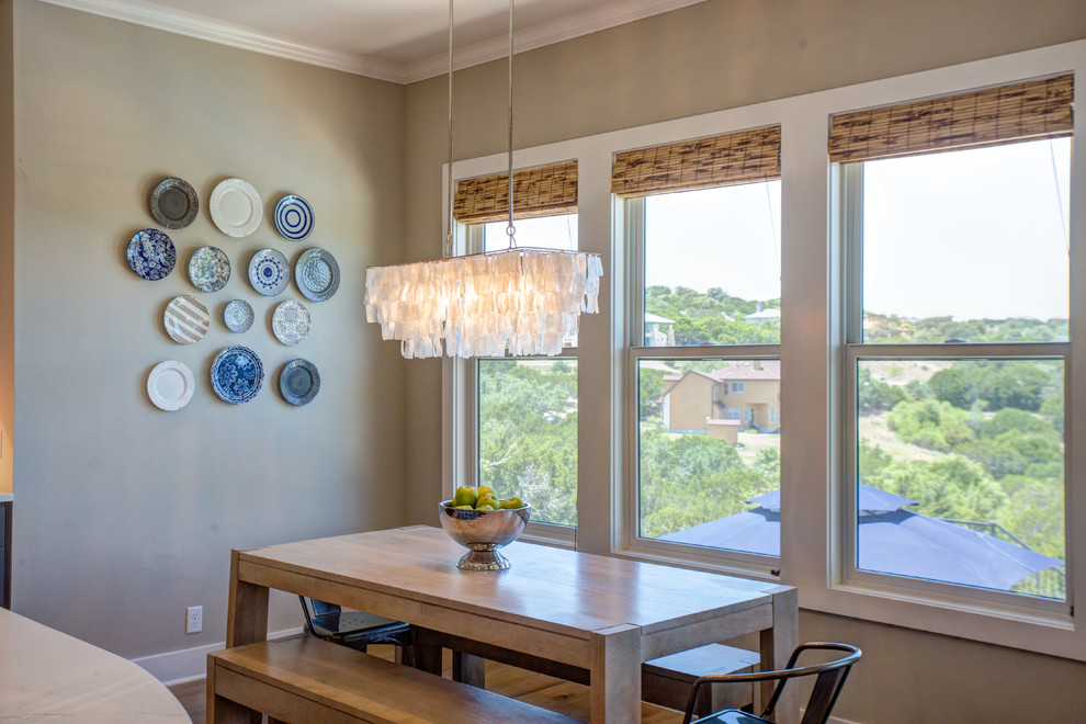Kitchen/dining room combo - mid-sized transitional light wood floor and beige floor kitchen/dining room combo idea in Austin with a farmhouse sink, shaker cabinets, white cabinets, quartz countertops, white backsplash, subway tile backsplash, stainless steel appliances, an island, beige walls and no fireplace