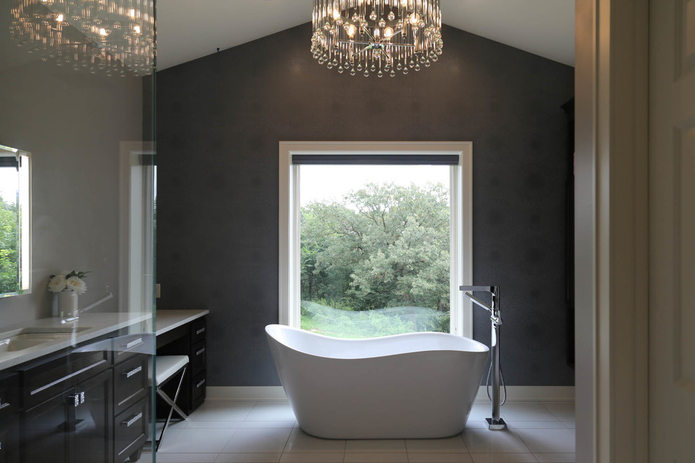 Mid-sized transitional master white tile and porcelain tile porcelain tile and white floor freestanding bathtub photo with recessed-panel cabinets, dark wood cabinets, a two-piece toilet, gray walls, an undermount sink, quartzite countertops, a hinged shower door and white countertops