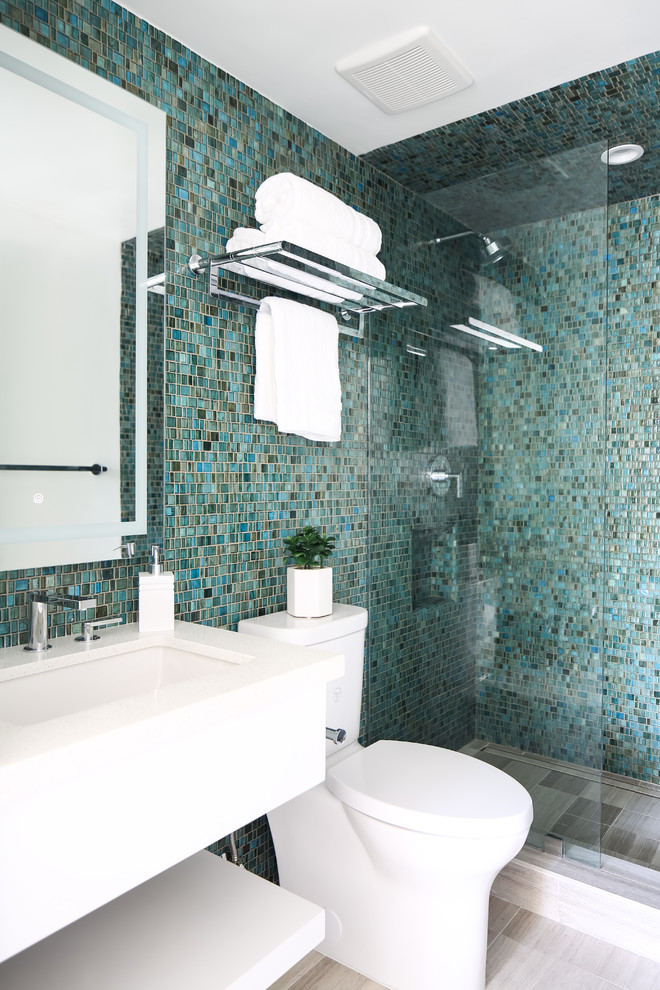 Inspiration for a beach style bathroom in San Diego with flat-panel cabinets, white cabinets, an alcove shower, blue tile, blue walls, mosaic tile floors, an undermount sink, grey floor, an open shower and white benchtops.