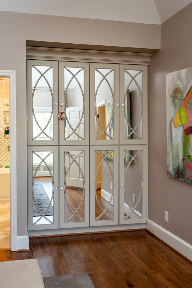 Example of a mid-sized transitional master dark wood floor and brown floor bedroom design in Charlotte with pink walls