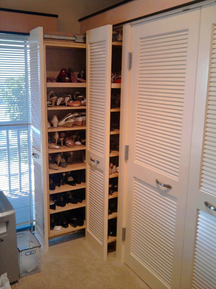 Photo of a mid-sized tropical storage and wardrobe in San Diego with carpet.