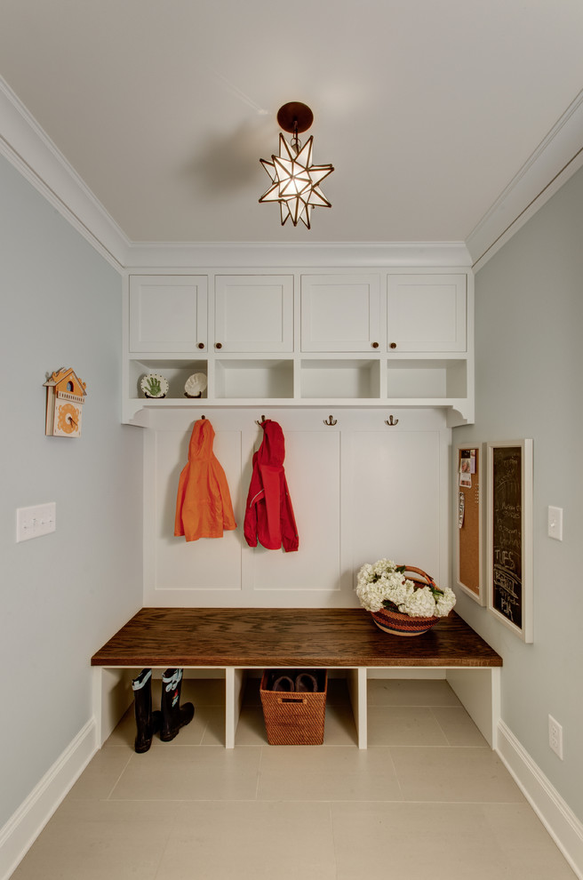 Design ideas for a traditional mudroom in Portland with white walls.