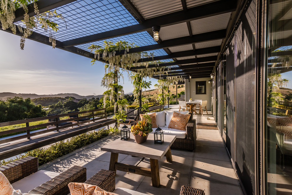 Design ideas for a country backyard verandah in San Luis Obispo with concrete pavers.