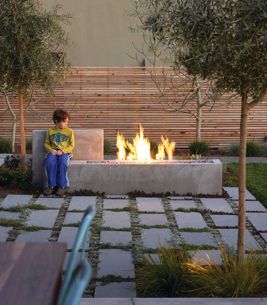 Design ideas for a large modern backyard patio in San Francisco with a fire feature, concrete pavers and a pergola.