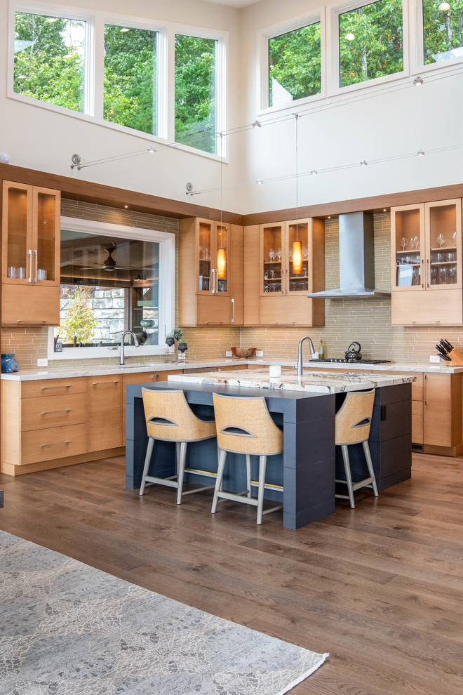 Large midcentury u-shaped open plan kitchen in Other with an undermount sink, flat-panel cabinets, light wood cabinets, stainless steel appliances, dark hardwood floors, with island, brown floor and beige benchtop.