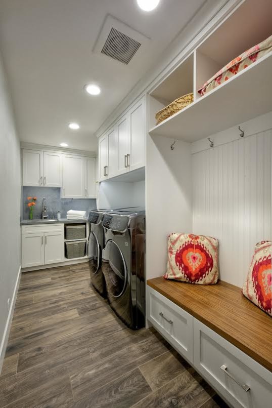 This is an example of a mid-sized traditional l-shaped utility room in Sacramento with an undermount sink, shaker cabinets, white cabinets, brown walls, a side-by-side washer and dryer, brown floor, grey benchtop, quartz benchtops and porcelain floors.