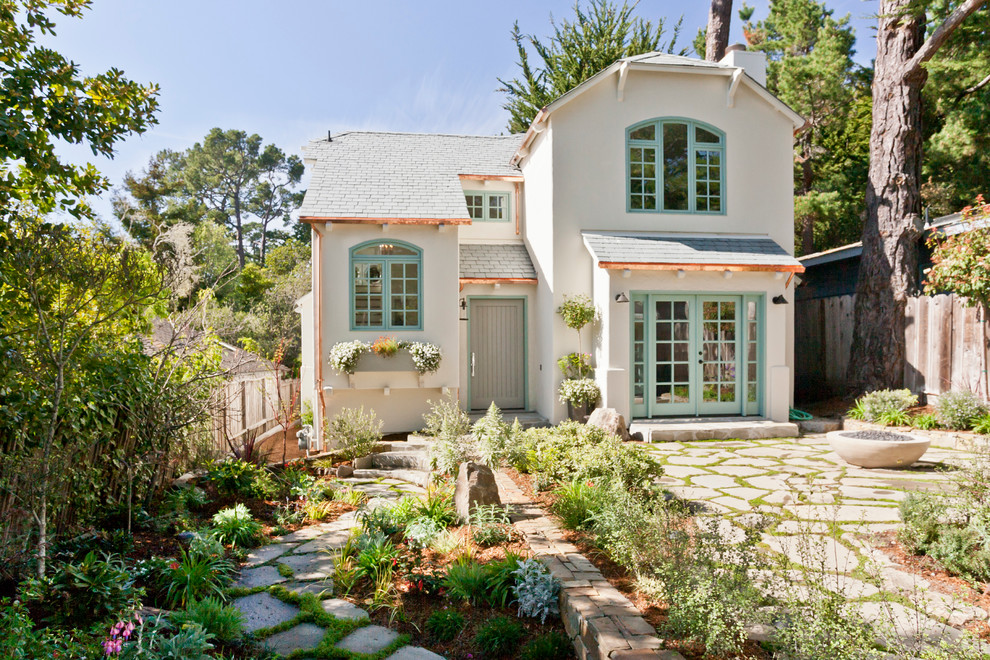 Beach style two-storey stucco white exterior in San Francisco with a clipped gable roof.
